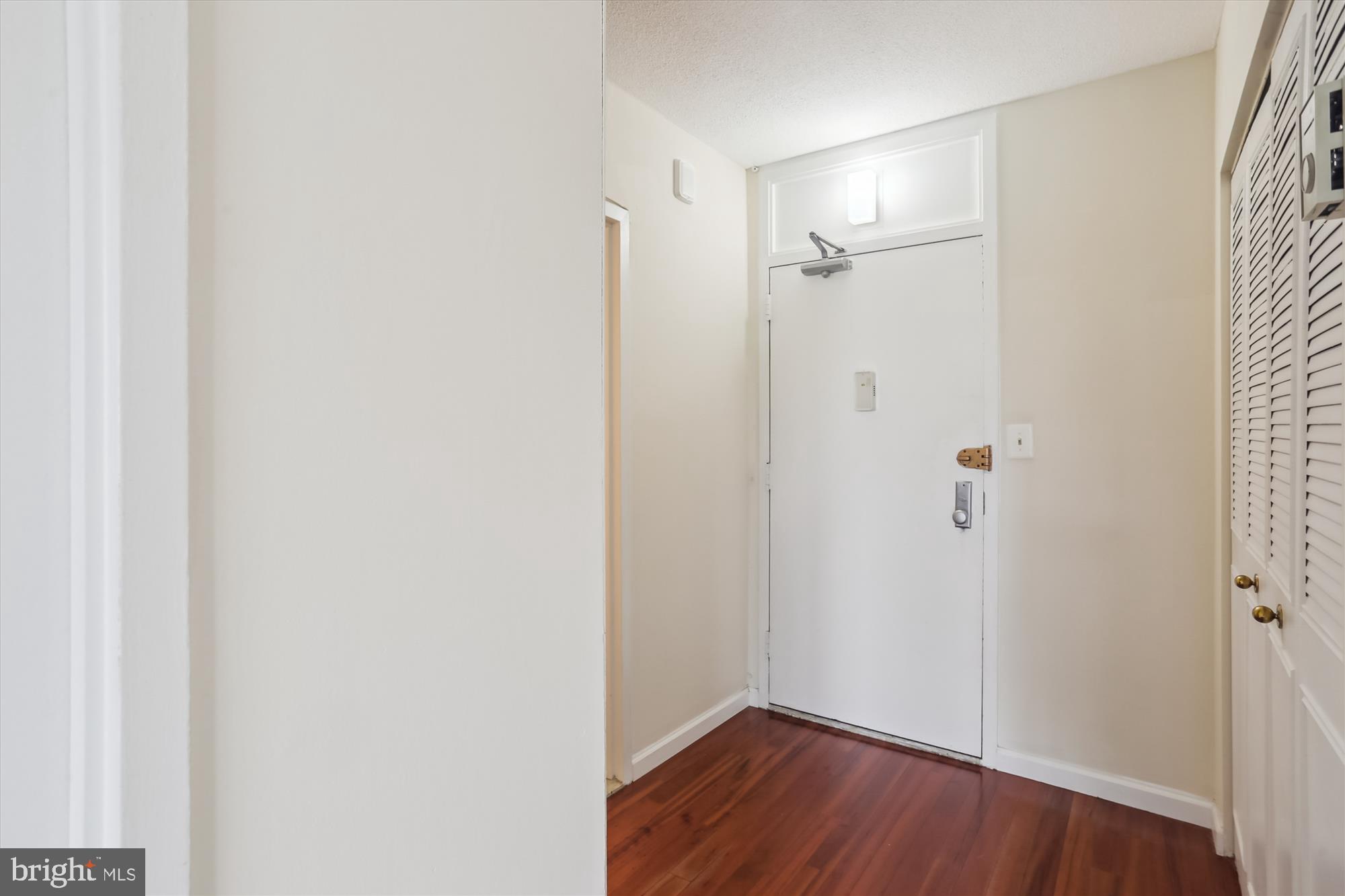 4242 East-West Highway, Unit 414 Chevy Chase, MD 20815 - Photo 10 of 66 a view of a small space with wooden floor and a bathroom