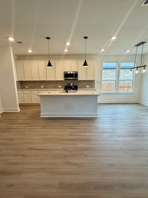 121 Prodigal Way Kyle, TX 78640 - Photo 5 of 12 a large kitchen with stainless steel appliances granite countertop a large counter top a sink and a stove