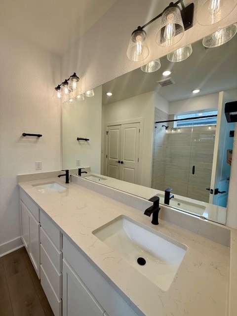 121 Prodigal Way Kyle, TX 78640 - Photo 9 of 12 a bathroom with a sink a shower a mirror and shower