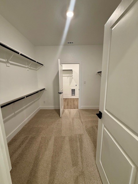 121 Prodigal Way Kyle, TX 78640 - Photo 10 of 12 a view of a room with wooden floor and white walls