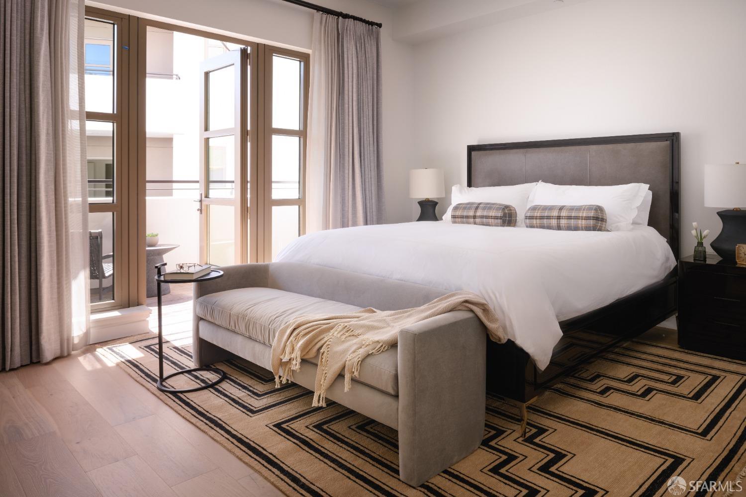 36 Meadow Drive, Unit 202 San Francisco, CA 94130 - Photo 17 of 50 a bedroom with a bed and wooden floor