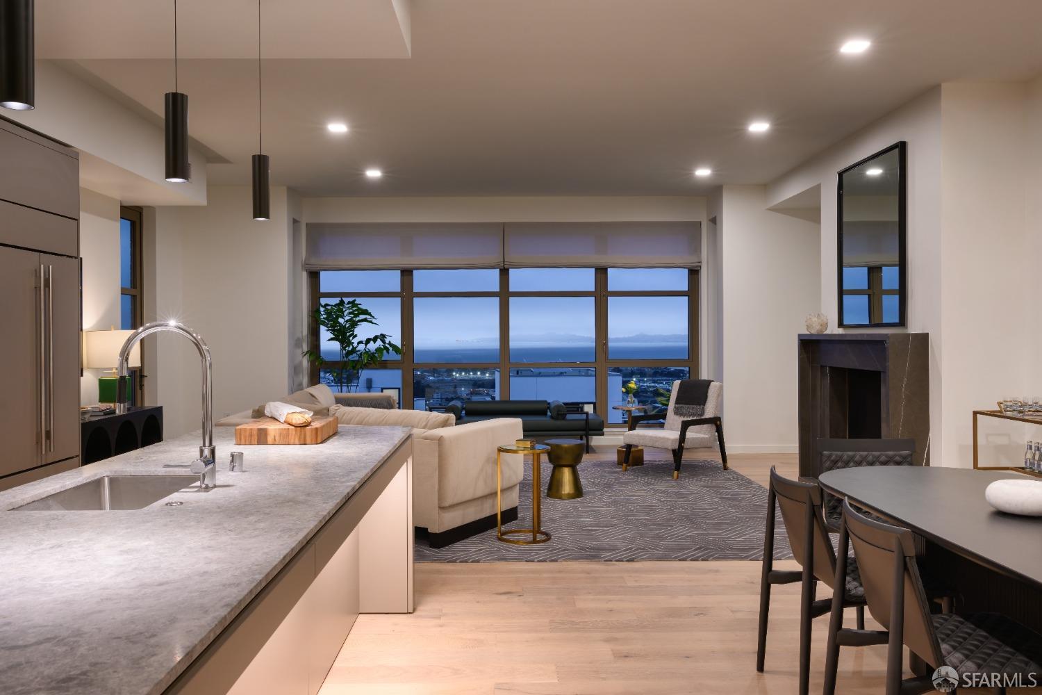 36 Meadow Drive, Unit 202 San Francisco, CA 94130 - Photo 5 of 50 a living room with furniture a large window and a fireplace