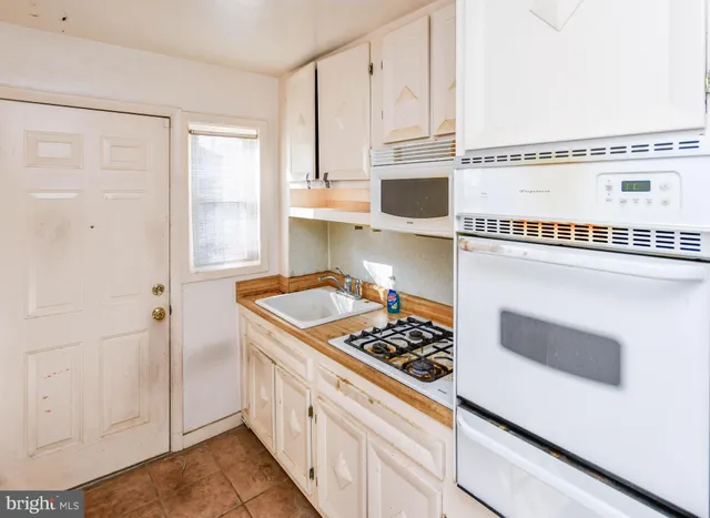 a kitchen with stainless steel appliances granite countertop a stove and a microwave
