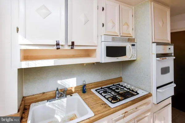 a kitchen with stainless steel appliances a stove and a microwave