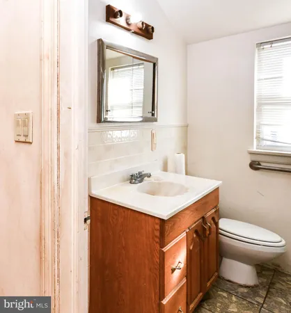 a bathroom with a sink a toilet and mirror