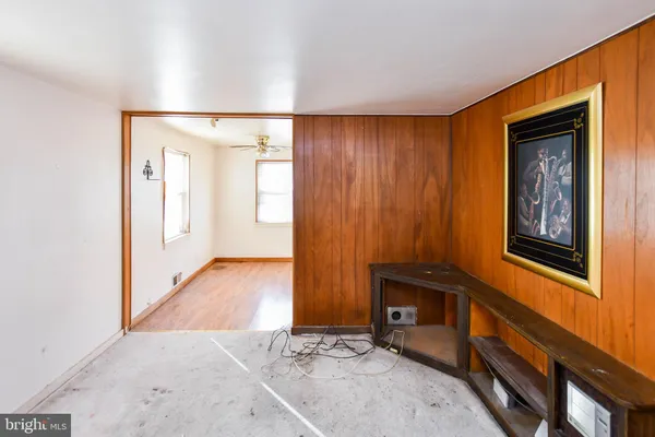 wooden floor with windows and brick walls