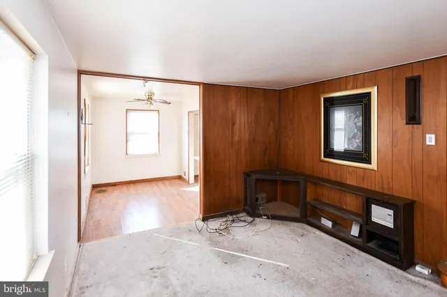 an empty room with windows and closet