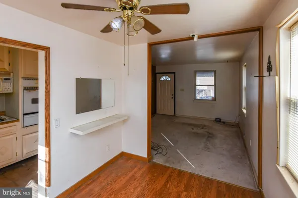 a view of a livingroom with a ceiling fan and window