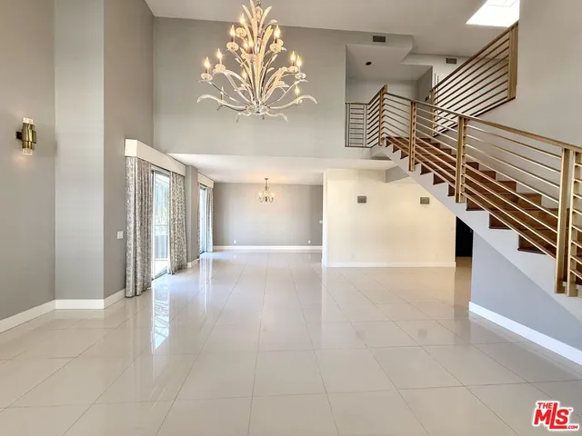 a view of a hallway with entryway and stairs