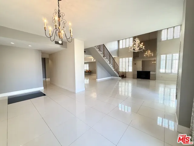 a dining room with furniture a chandelier and window