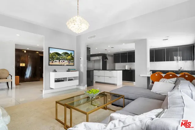 a living room with furniture windows and a chandelier