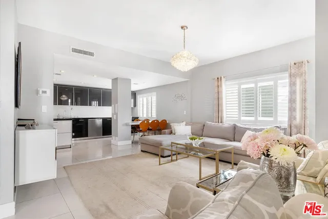 a kitchen with stainless steel appliances kitchen island sink refrigerator and stove