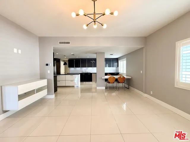 a kitchen with granite countertop a sink and cabinets