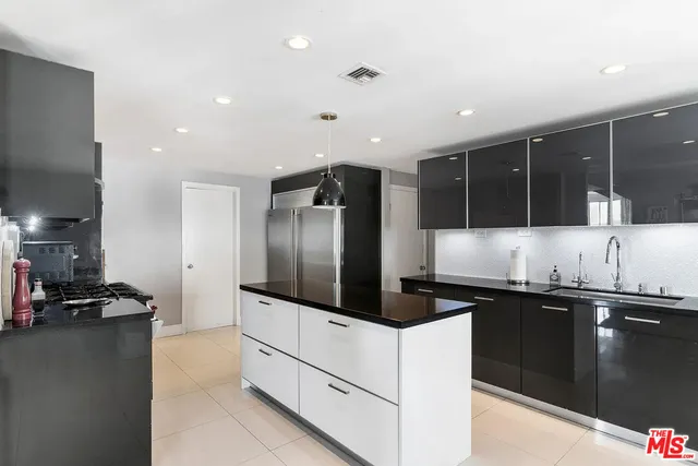 a kitchen with stainless steel appliances a stove and a microwave