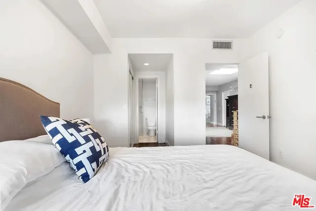 a bedroom with a bed a table and chair