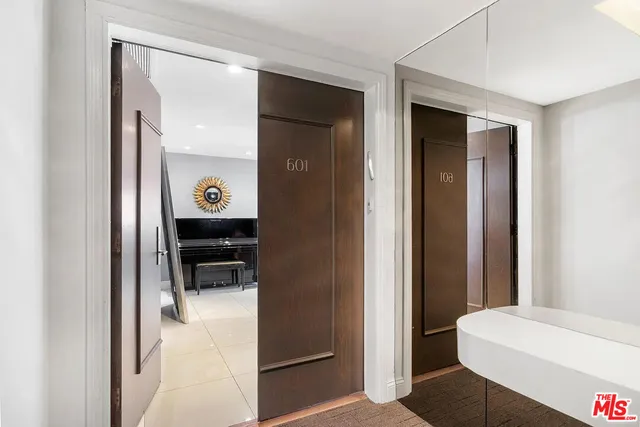 a view of a hallway with wooden cabinets