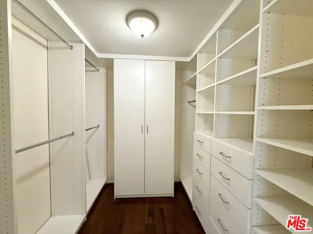 a room with gym equipment and wooden floor