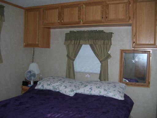 509 La Moille Road, Unit 2408 Sublette, IL 61367 - Photo 4 of 14 a bedroom with a bed and cabinets