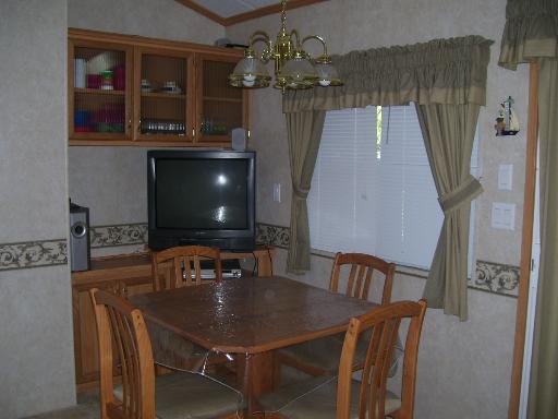 509 La Moille Road, Unit 2408 Sublette, IL 61367 - Photo 8 of 14 a living room with furniture and a flat screen tv
