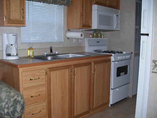 509 La Moille Road, Unit 2408 Sublette, IL 61367 - Photo 9 of 14 a kitchen with stainless steel appliances granite countertop a sink a stove and cabinets