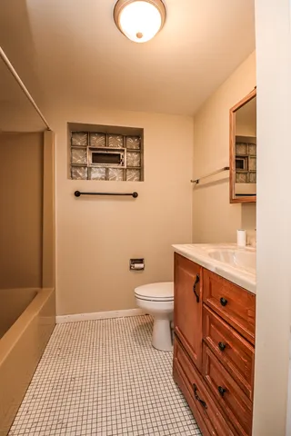 a room with a refrigerator and a microwave