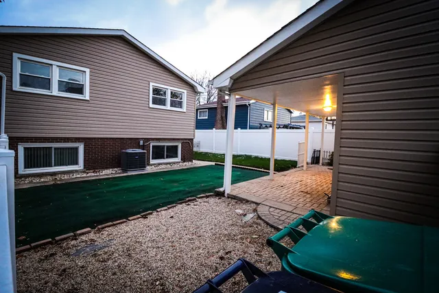 a view of a backyard with plants and a patio