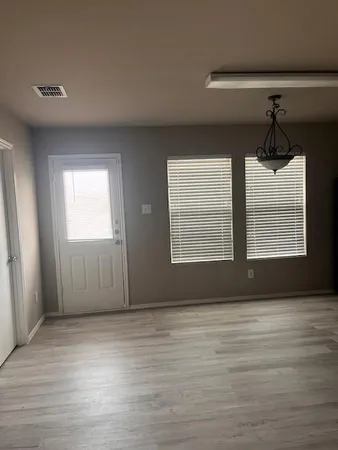 a view of wooden floor and windows in a room