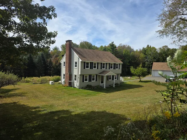 a view of a house with garden and sitting area