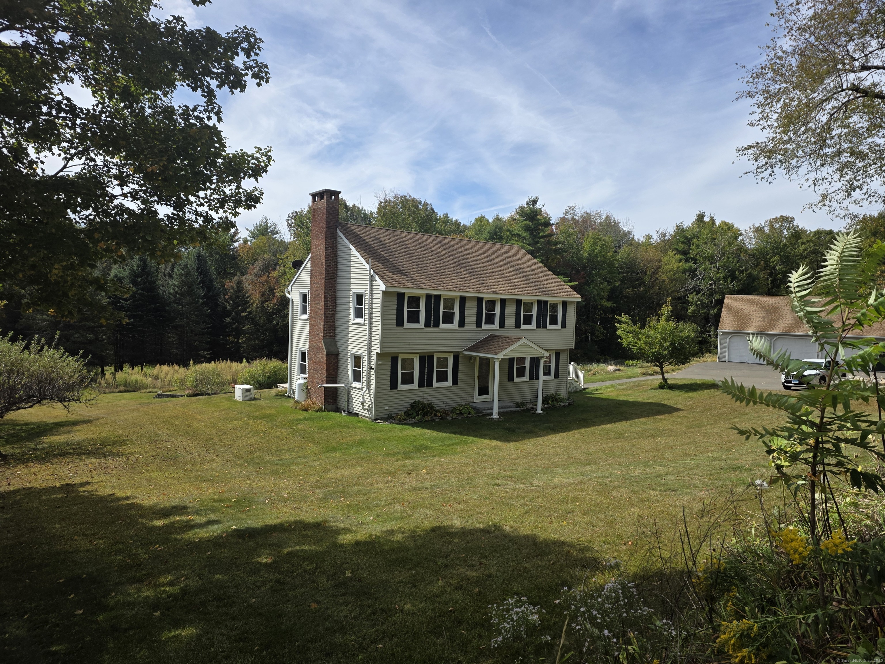 a view of a house with garden and sitting area