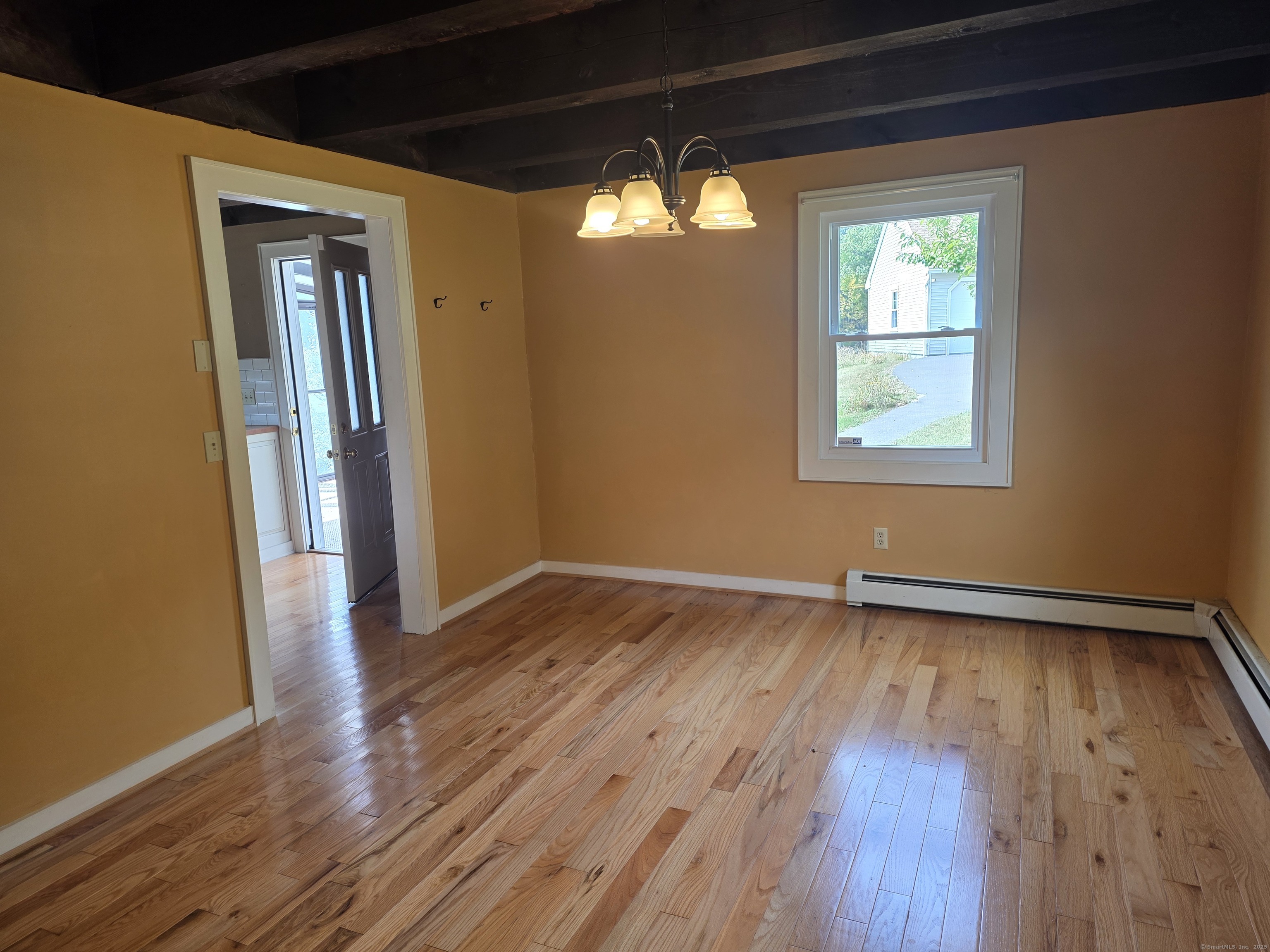 70 Colebrook Road Norfolk, CT 06058 - Photo 11 of 23 an empty room with wooden floor and windows