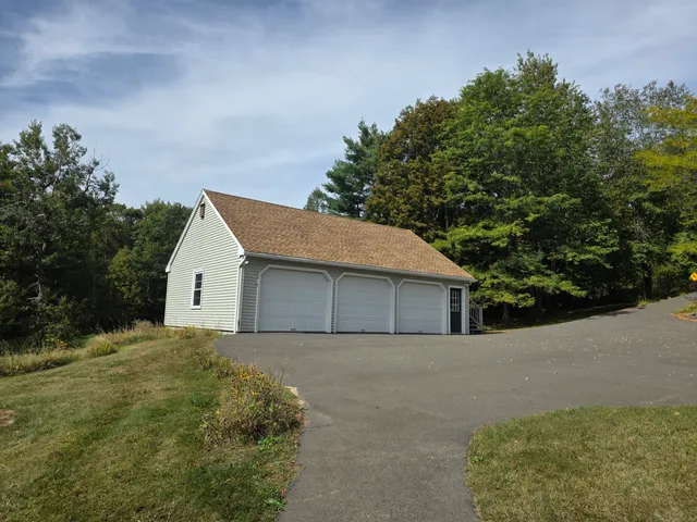a backyard of a house with plants and trees