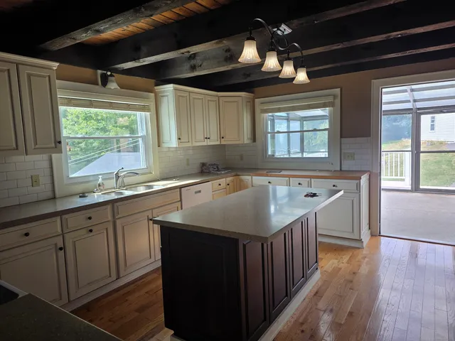 a kitchen with stainless steel appliances a sink stove and cabinets