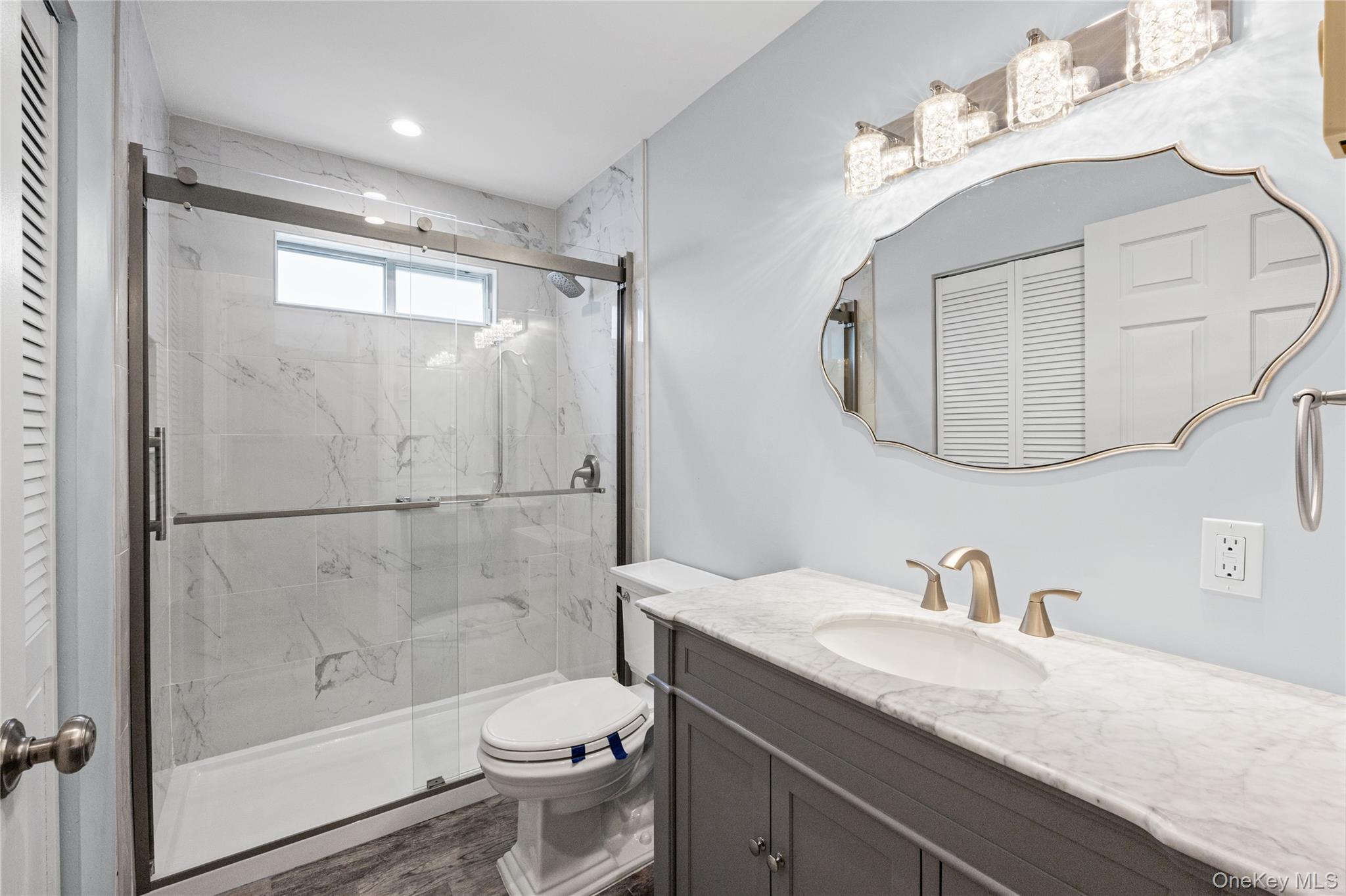 220 Belfast Lane Ridge, NY 11961 - Photo 40 of 44 a bathroom with a granite countertop sink toilet and shower