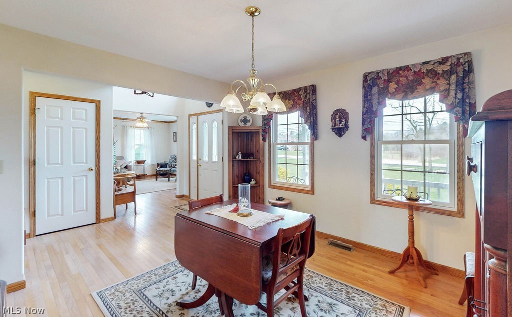 10147 Page Road Streetsboro, OH 44241 - Photo 5 of 35 Dining area with light hardwood / wood-style floors and ceiling fan with notable chandelier