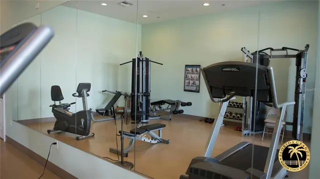 a view of a workspace with furniture and gym equipment