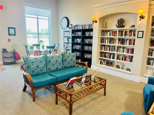 a living room with furniture and a book shelf