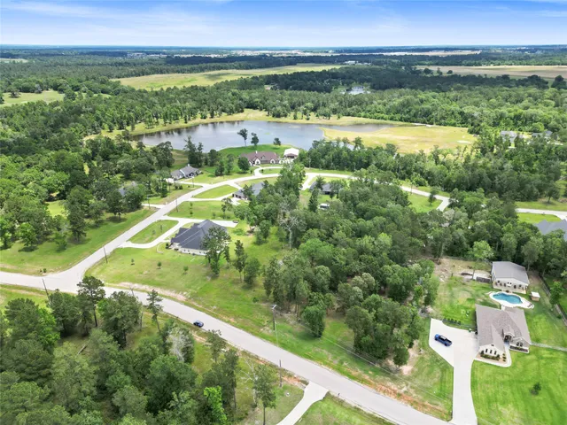 an aerial view of residential houses with outdoor space and city view