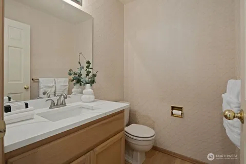 a bathroom with a sink a toilet and a mirror