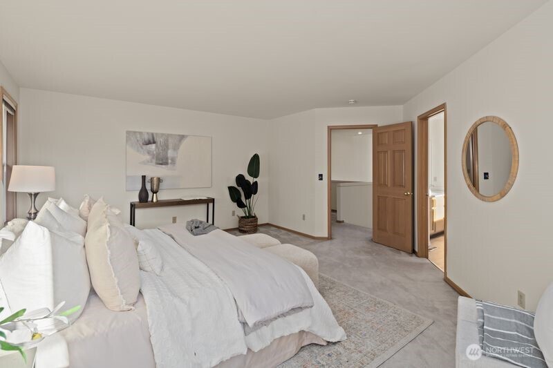 14610 Southeast 184th Place Renton, WA 98058 - Photo 13 of 31 a spacious bedroom with a bed and a mirror
