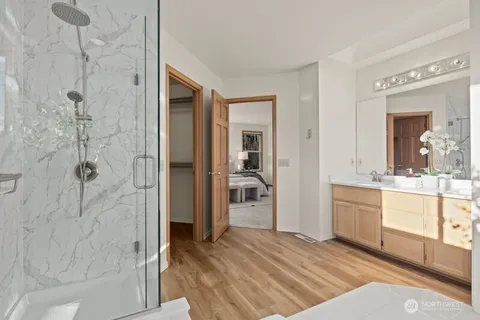 a bathroom with a granite countertop shower a sink and a mirror