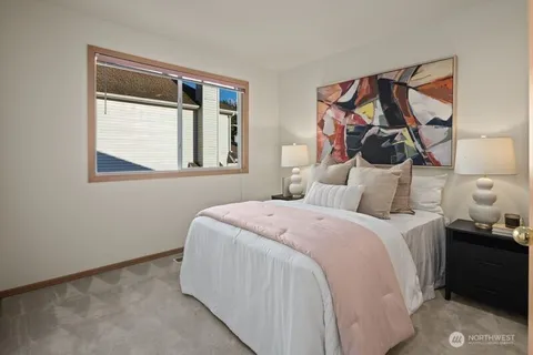 a bedroom with a bed and a painting on the wall