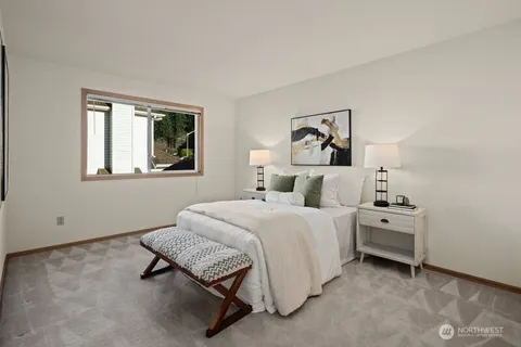 a spacious bedroom with a bed and a painting on the wall