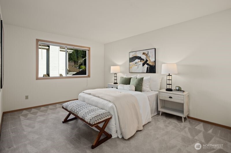 14610 Southeast 184th Place Renton, WA 98058 - Photo 20 of 31 a spacious bedroom with a bed and a painting on the wall