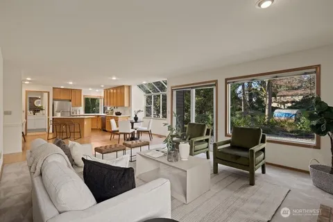 a living room with furniture and floor to ceiling windows
