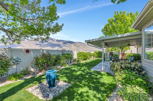 1602 Renaissance Way Springville, UT 84663 - Photo 33 of 42 Fenced backyard featuring a ceiling fan, a patio area, and a mountain view
