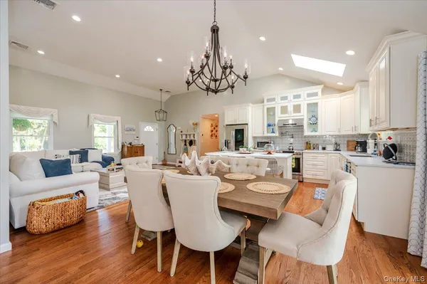 a view of a dining room with furniture wooden floor and chandelier