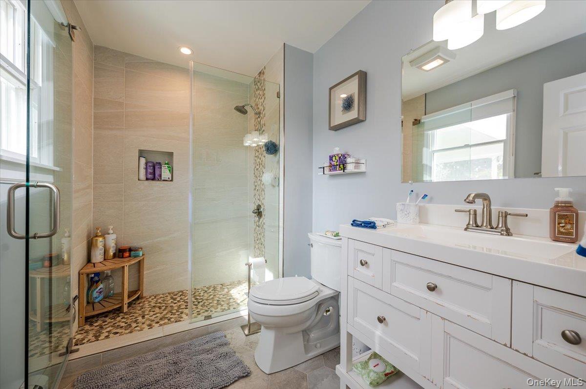 525 Rocky Point Road East Marion, NY 11939 - Photo 17 of 48 a bathroom with a granite countertop sink mirror vanity and toilet