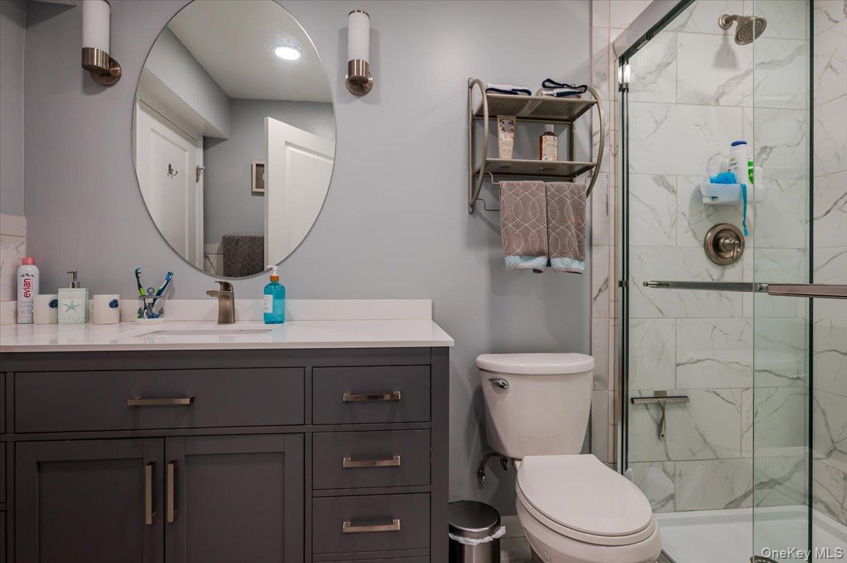 525 Rocky Point Road East Marion, NY 11939 - Photo 18 of 48 a bathroom with a toilet sink and shower