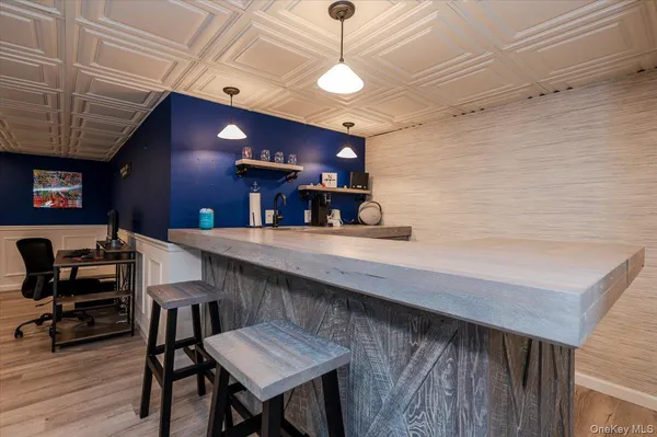 a kitchen with a table chairs and wooden floor