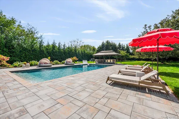 a view of a house with a yard and sitting area